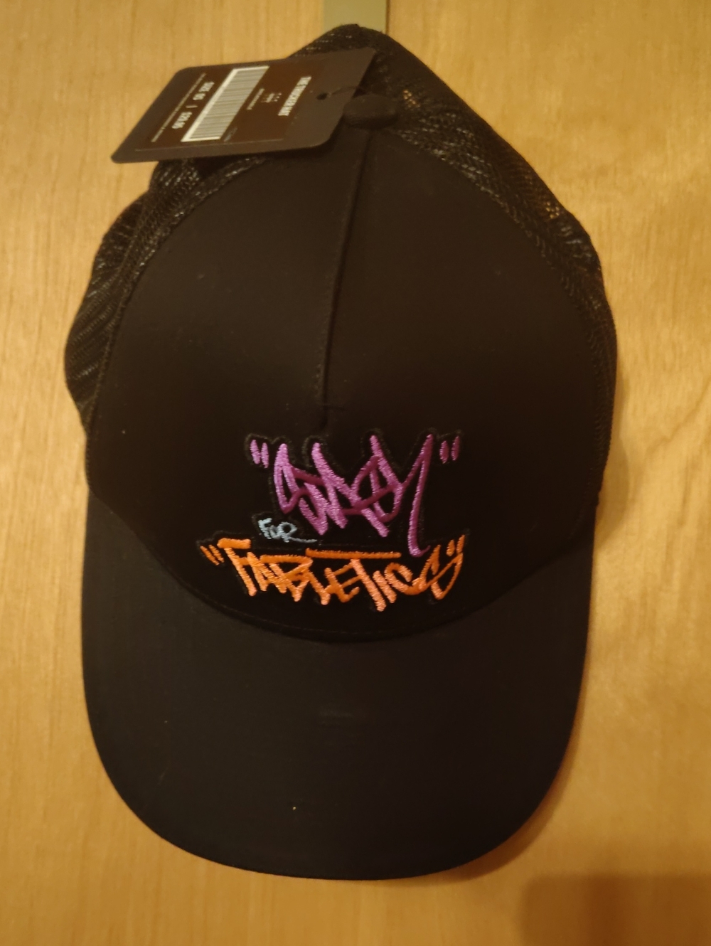 Fabletics Black Trucker Hat with Purple and Orange Embroidered Logo